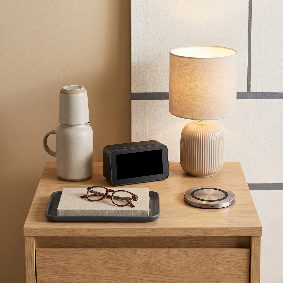 Nightstand with a ceramic lamp, alarm clock, wireless charging pad, carafe and tray