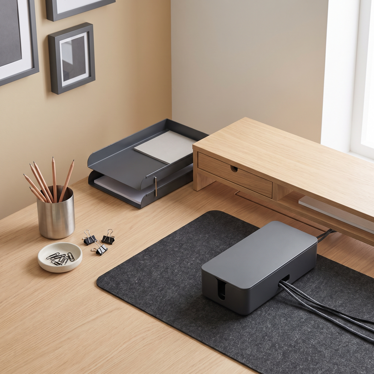 Desk with a felt mat, pen pot, document tray, cable box and monitor riser