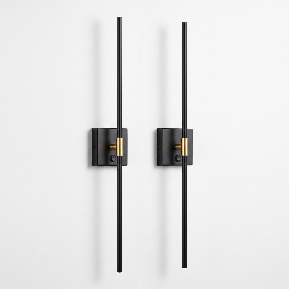 Ansel cordless wall sconces, set of two — slim black metal rods on small square wall plates with a brass collar, on a white background