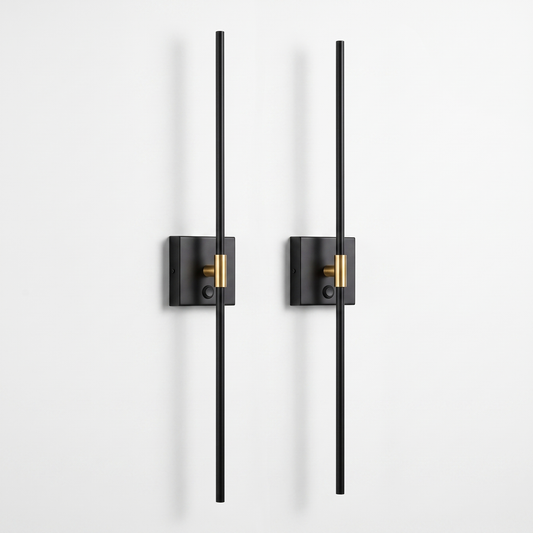 Ansel cordless wall sconces, set of two — slim black metal rods on small square wall plates with a brass collar, on a white background