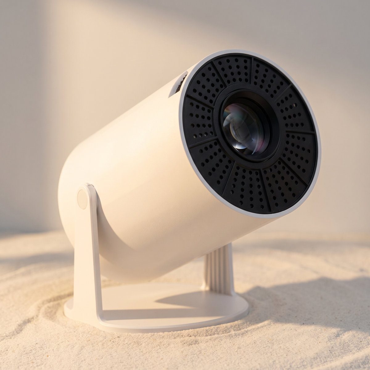 Close detail of the projector's swivel hinge, base and perforated lens housing