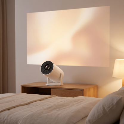 The projector on a bedroom console, tilted up, casting a large soft rectangle of light on the wall
